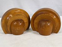 Front view of both wood bookends showing semi-circular Art Deco design and condition.