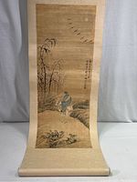Photo showing the full painted scroll with a person walking along a path, trees, birds in flight, and calligraphy.
