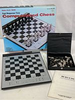 Vintage Radio Shack 1650 Computerized Chess game with original box, instruction manual, and chess pieces displayed on a table
