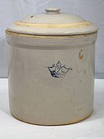 Full front view of the vintage two gallon crown crock with lid showing the overall shape and wear.