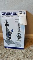 Boxed Dremel Workstation model 220-01 with branding and instructions visible on packaging.