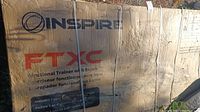 Cardboard shipping box labeled Inspire FTXC Functional Trainer with Bench, multilingual text