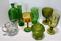 All eight vintage glass pieces together showing color and variety