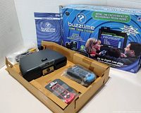 Full lot including Buzztime Trivia console, two controllers in red and blue, original box, and user manual.