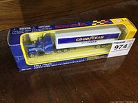Front view of boxed Goodyear Big Rigs semi-truck showing blue cab, white trailer with Goodyear logo, and original packaging.