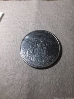 Front side of the silver dollar coin showing Jacques Cartier design with inscriptions.