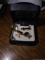 Full set of men's jewelry in a black Senator box, consisting of cufflinks, tie clip, and ring.