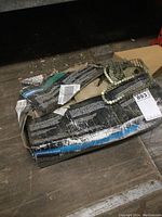 Box of coil roofing nails showing multiple coil strips of nails packed inside a cardboard box with label Metabo HPT and product details.