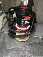 Black Craftsman router with power cord and base plate, showing speed control dial and handle.