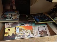 Stacked rack view showing Ozzy Osbourne Blizzard of Ozz, AC/DC black cover, Dirty Deeds Done Dirt Cheap and others