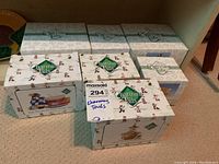 Seven Charming Tails collectible resin figurines in original boxes stacked on carpeted floor.