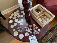 Overview of coins on table and in boxes