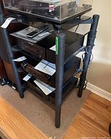 Three-quarter front view of the media stand loaded with components