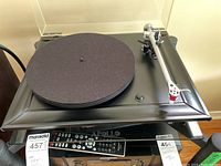 Full view of Rega P5 belt-drive turntable showing plinth, glass platter with mat and tonearm