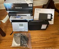 Front view of three Sony radios and bagged Cobra walkie talkies