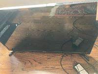 Front view of the black 32-inch Samsung flat screen TV showing screen and two legs