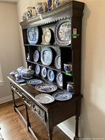 Front diagonal view of complete china hutch showing two-tier storage and top molding