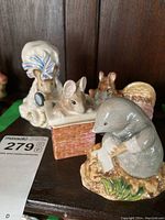 Front view showing multiple Beatrix Potter character figurines including a mole on a natural base, and a mouse in a chimney.