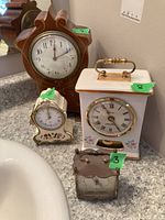 Four mantle clocks shown together on a countertop, numbered 3, 5, 7, 8 for identification.