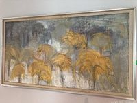 Frontal view of unsigned framed abstract painting showing organic shapes in yellow and gray color palette.