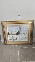 Framed original painting showing a snowy rural scene with a barn and leafless trees.