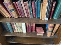 Overall shelf view of assorted hardcover vintage books