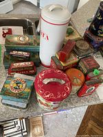 Overview of all tins displayed on countertop