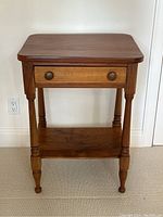 Front view of the antique pine table showing front drawer and turned legs