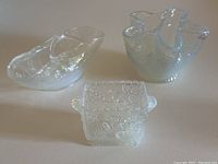 Three Sowerby opaline glass dishes arranged on a surface showing size and shape variety