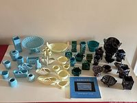 Overview of all 43 slag glass pieces arranged by color with the book in front