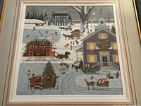 Full view of framed Christmas-themed art print featuring horses, sleighs, carolers, and snow-covered village buildings in winter.