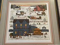 Close-up of the framed limited edition print showing village scene with houses, horse-drawn carriages and people in winter holiday setting.