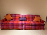 Front view of assembled two-piece sofa with three throw pillows