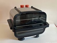 Front and angled view of the vintage Braun stainless steel convection oven showing glass door and wire racks inside.