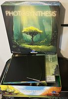 Top-down view of Photosynthesis game box with game components inside