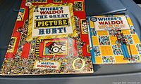 Photo showing two Where's Waldo books: 'The Great Picture Hunt!' and 'Games On The Go!'. Both have colorful covers with Waldo and other characters from the series.