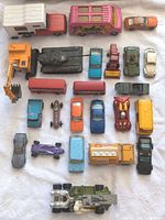 Full overview of all 24 vehicles in lot showing variety and condition on white towel surface.