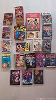 Full lot of mixed Nancy Drew books including various titles and series stacked and laid out on a floor surface.