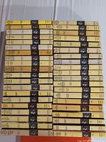 Stack of 40 Nancy Drew vintage books with yellow spines and volume numbers