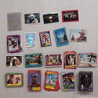 Array of various non-sport trading cards laid out including Star Trek, James Bond, ET, Batman, and other vintage series.