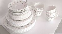 Stacked plates and tea cups showing pattern and quantity
