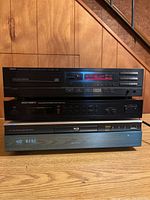 Stacked view of Yamaha CDX-520 CD player at top, Vector Research VU-1500 stereo tuner in the middle, Sony BDP-S1 Blu-Ray player at bottom showing the displays and control panels.