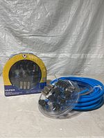 Photo of two Vaper air line kits including blue air hoses and connectors for compressed air outlets on wall.