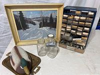 Wide shot showing entire lot including painting, watch/clock parts organizer, Mason jars, duck decoy, and brass tray
