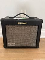 Front view of the Kustom Arrow 16 amplifier showing 'Kustom' logo and 'Powered by Celestion' badge on speaker grille.