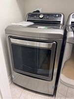 Front view of LG dryer showing stainless steel door and overall condition