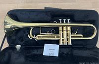 Full trumpet inside black hard case, showing trumpet and included mouthpiece.