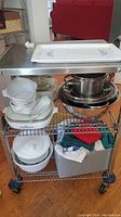 Full view of kitchen cart with all items including Corning Blue Cornflower bakeware, Pyrex bowls, stainless steel bowls, and salad spinner.