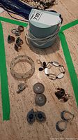 Full view of jewelry lot with bracelets, rings, and various earrings arranged on table