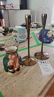 Photo showing the Toby mug and two Dansk candle sticks on a table, with visible wear on metal candlesticks.